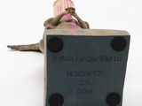 a small figurine of a woman sitting on a box