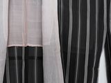a black and white striped shirt hanging on a wall