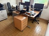 a desk with two monitors and a printer on it