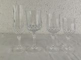 four wine glasses sitting on a table next to each other