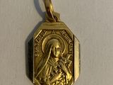a close up of a gold medal with a picture of a woman on it