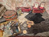 a table with a lot of items on it that include gloves, a hat, and other items
