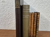 three books are stacked on top of each other on a table