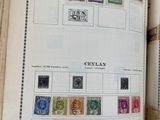 an open book with stamps on it on a table