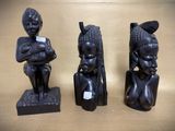 three african figurines sitting on top of a table next to each other