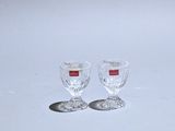 two empty wine glasses sitting on a white surface