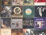 a lot of records on the wall of a room