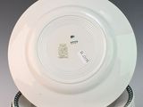 several white plates stacked on top of each other on a table