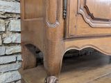 a wooden cabinet sitting on top of a wooden table