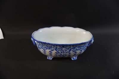 blue and white bowl on black table with black background