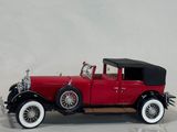 a model of a red car with a black top