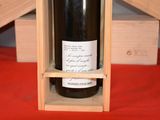 a bottle of wine in a wooden box on a table