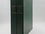 a black book with gold trims and a green cover on a white background