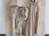 a statue of a man standing next to a fire place