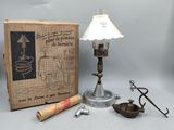 a lamp that is sitting on a table next to a book and a pair of scissors