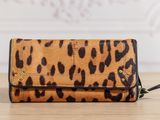a leopard print wallet purse on a wooden table