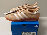 adidas gazelle trainers in tan and white on a blue box