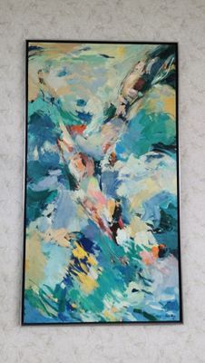 painting on the wall of a living room with a couch and a painting on the wall