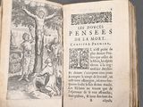 an open book with an image of jesus on the cross
