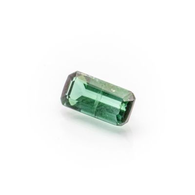 a green tourmaline gems on a white background