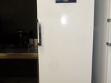 a white refrigerator sitting in a kitchen next to a shelf