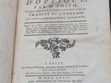 an old book that is open on a table