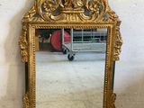 a mirror that is sitting on the floor in front of a wall