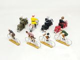 many figurines of people riding bikes on a white surface