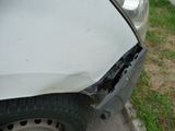 a car that has been damaged and is sitting on the side of the road