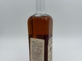 an image of a bottle of whiskey sitting on a white surface