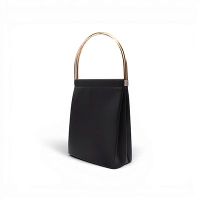 a black handbag with a gold handle on a white background