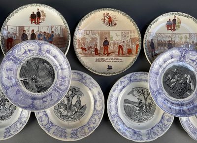 several blue and white plates with pictures of people and animals on them