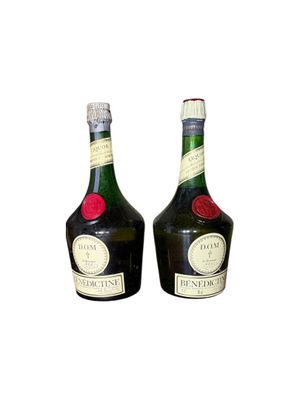 two bottles of liquor sitting next to each other on a white surface