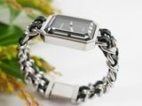 a black and silver watch on a silver chain bracelet
