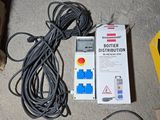 a box of electrical equipment on the floor next to a box of wires