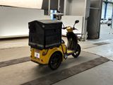 a scooter with a cart on the back of it