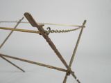 an image of a gold metal clothes rack with a chain hanging from it