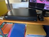 a dvd player sitting on top of a desk next to a computer monitor