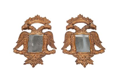 pair of gilded mirrors with eagle heads and a mirror in the middle