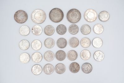 a lot of silver coins on a white surface