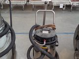 two vacuums that are sitting in a room