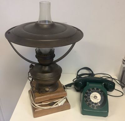 a table with a lamp and a telephone on it