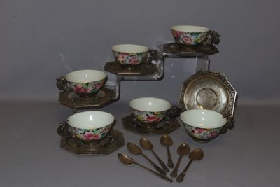 a lot of cups and spoons that are on the table
