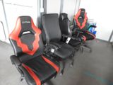 several black and red racing seats are lined up in a row