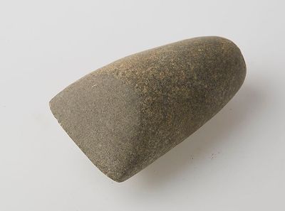 a small rock that is sitting on a white surface
