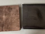 two pieces of brown and black leather sitting next to each other