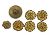 a close up of a bunch of metal buttons on a white surface