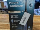 packaging of a philips soniccare electric toothbrush on a wooden table