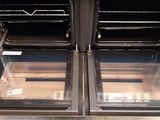 two open ovens that are sitting on the floor