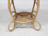 a wicker table with a glass top on a white floor